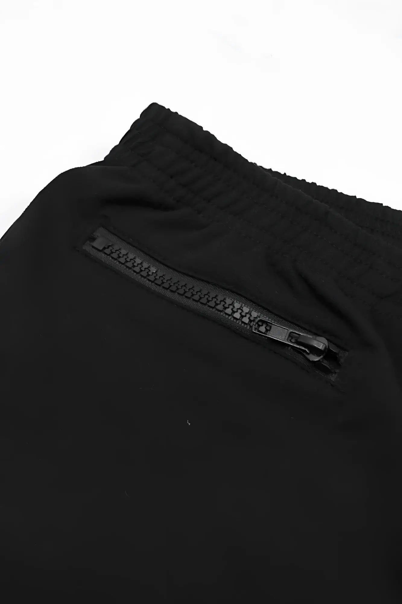 Black athletic pants with ribbed elastic waistband and front zippered pocket for comfortable active wear