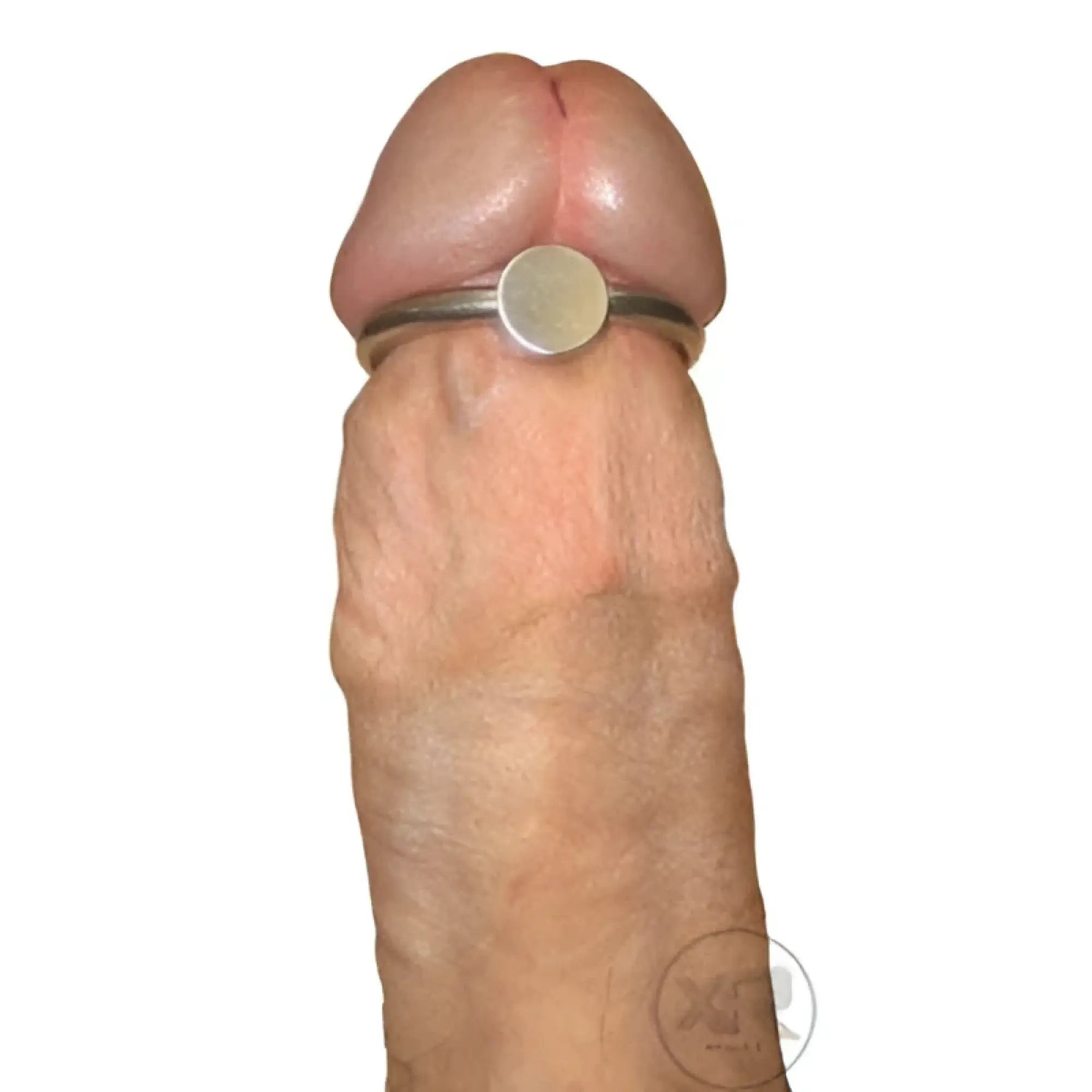 Silver-toned penis head glans ring with smooth flat center band and pressure point worn at base of erect penis