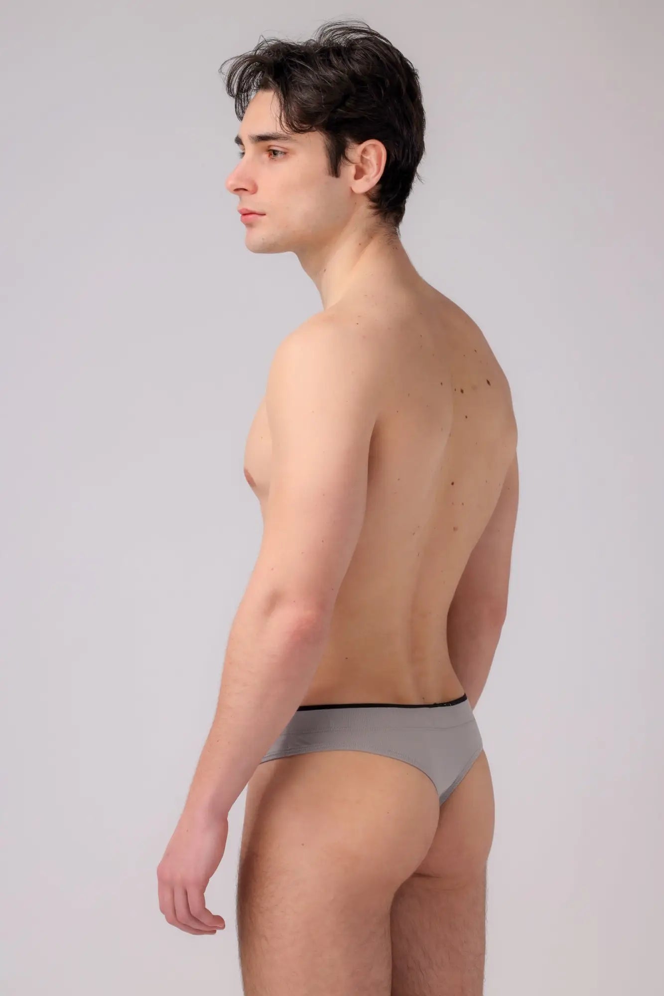 As performance thong gray briefs with thin black waistband showing front side in breathable fabric