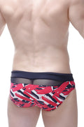 Red black and white abstract brushstroke swim trunks with navy blue mesh waistband from petitq bikini ajoupa chick