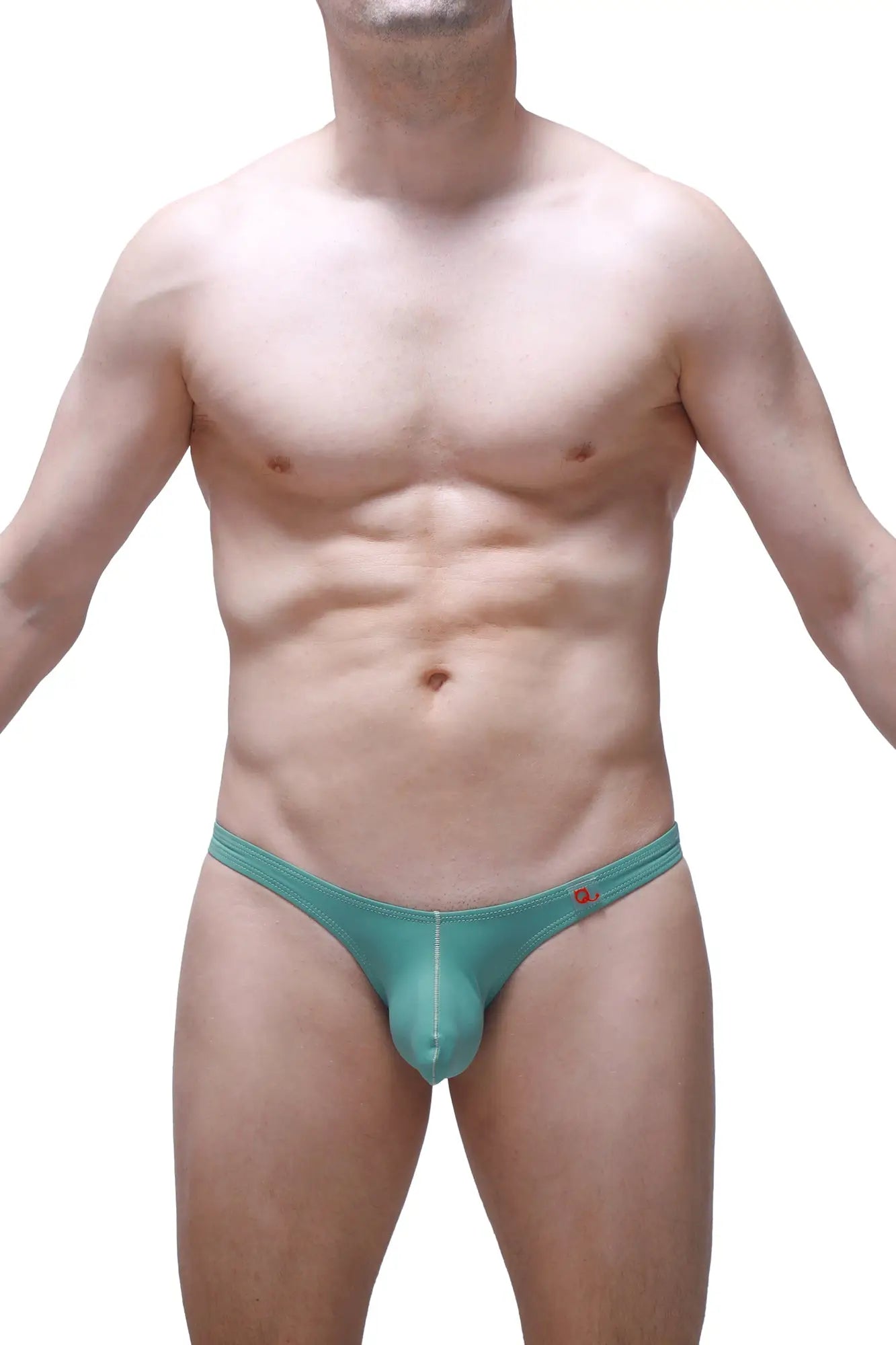 Teal-colored form-fitting men’s thong with subtle seam detail and small red logo on the waistband petitq bikini dome green