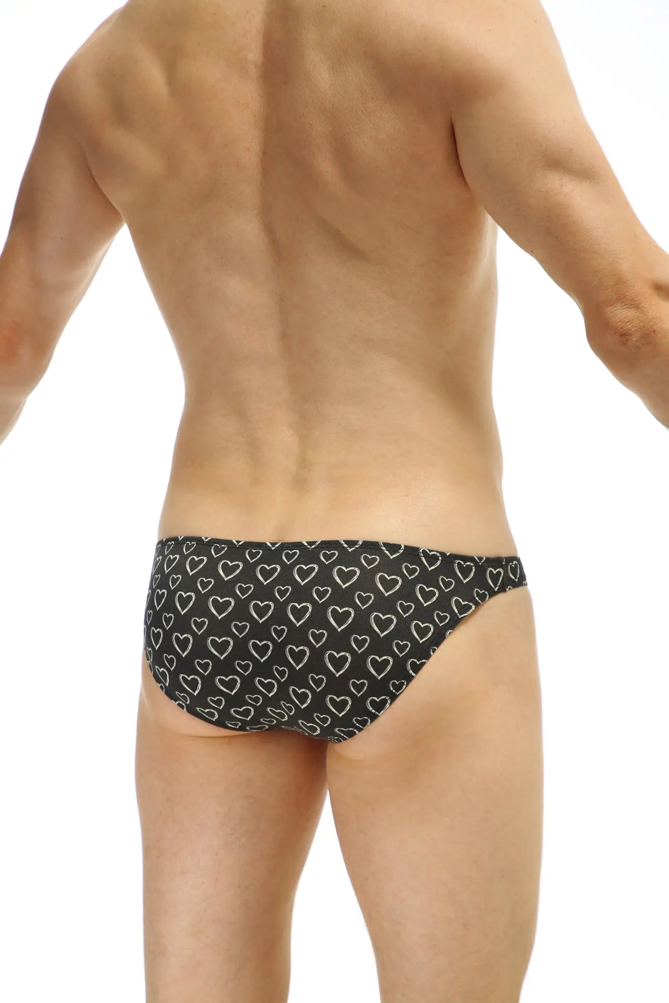 Black PetitQ bikini briefs featuring a repeating pattern of white outlined hearts on soft fabric