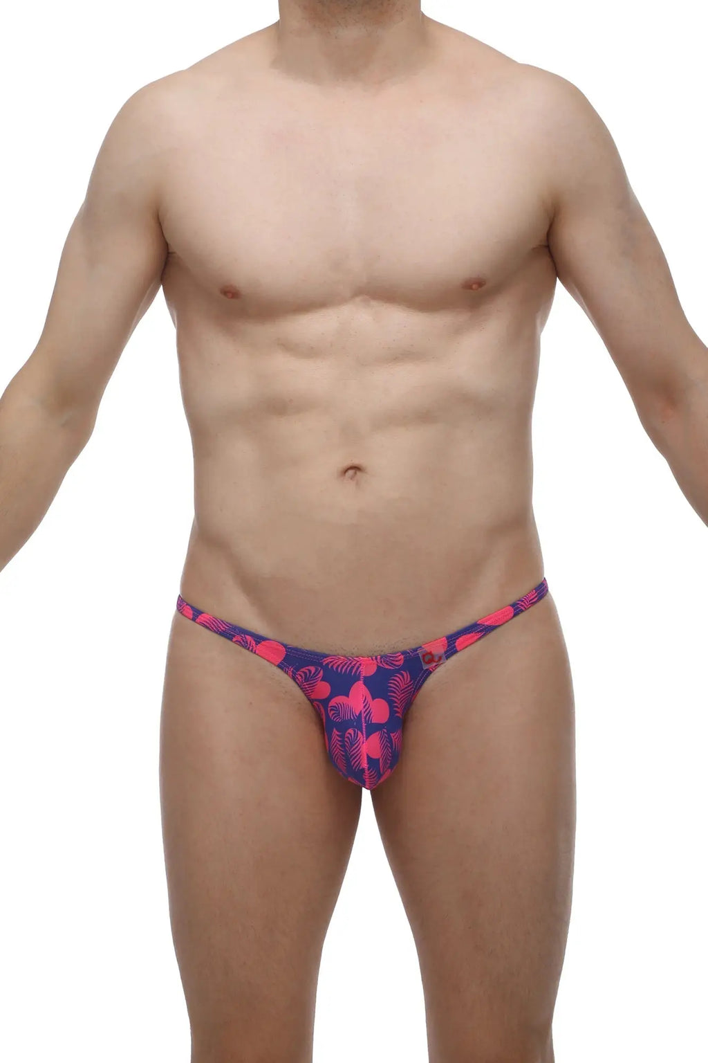 A vibrant pink and navy blue thong from PetitQ bikini plellis tropical hearts with a tropical leaf pattern