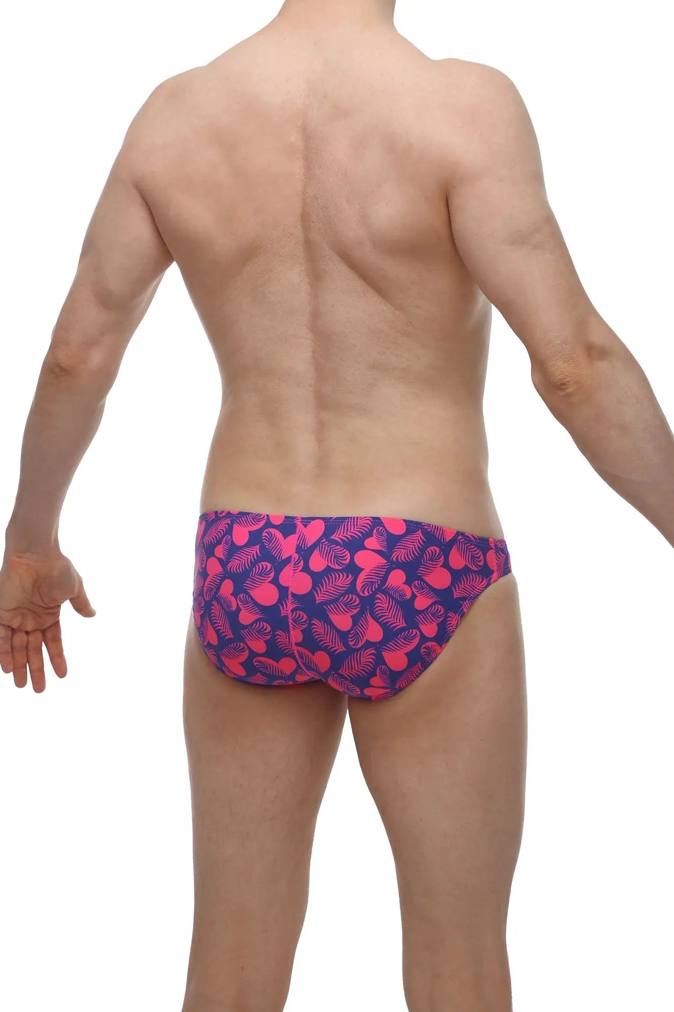 Vibrant pink and navy blue petitq bikini taik tropical hearts swim trunks with playful tropical leaf pattern