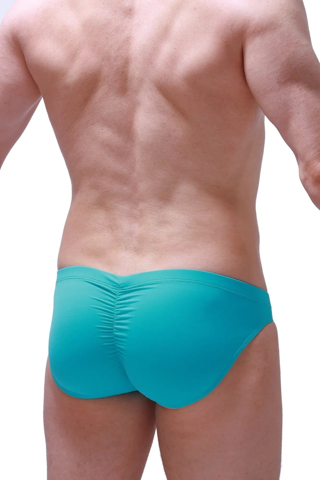Back view of turquoise petitq brief peraut green swim trunks with ruched design made of quick-dry fabric