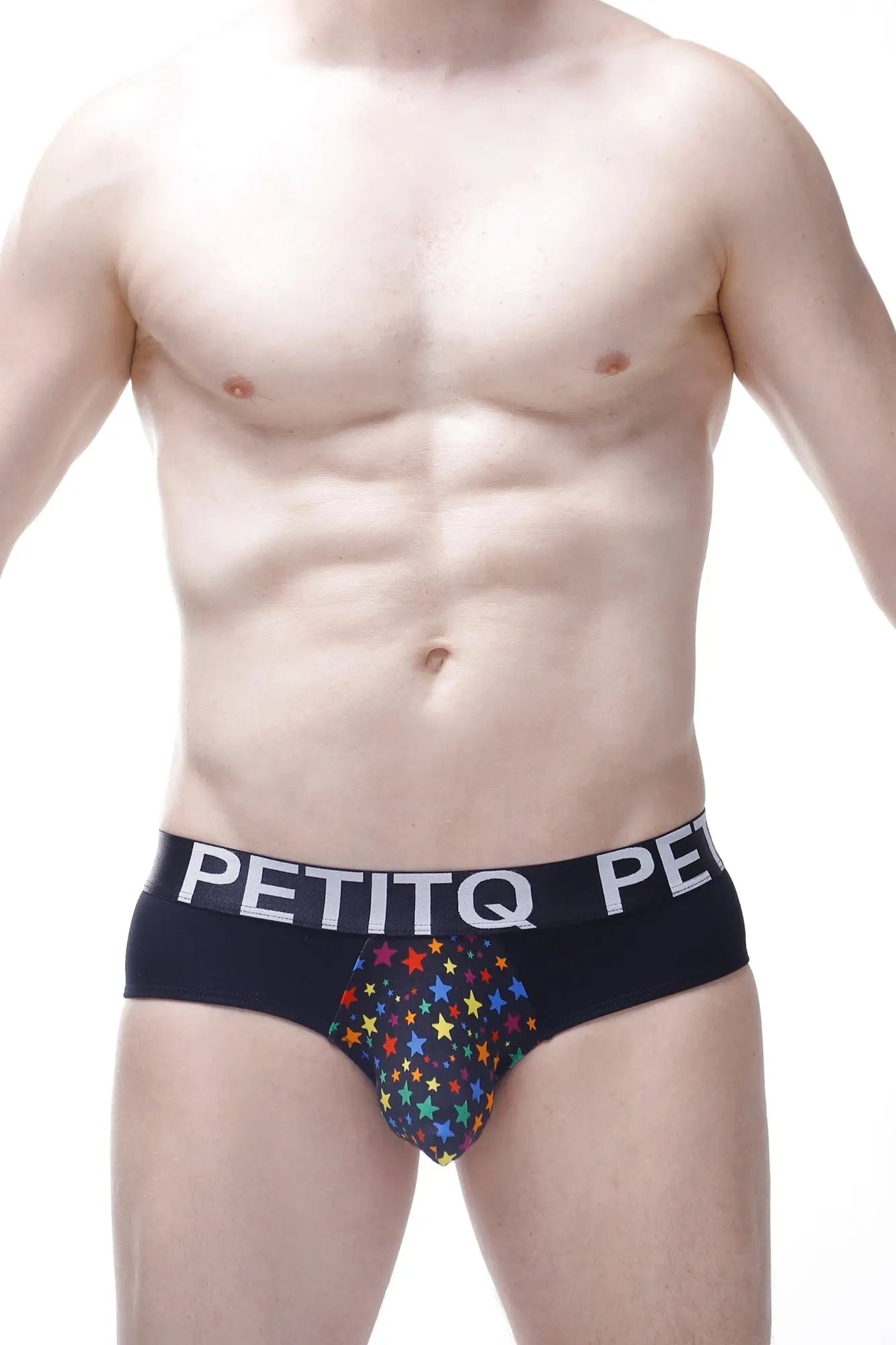 Black men’s briefs with colorful rainbow star pattern and petitq branding on white waistband in petitq brief stars rainbow