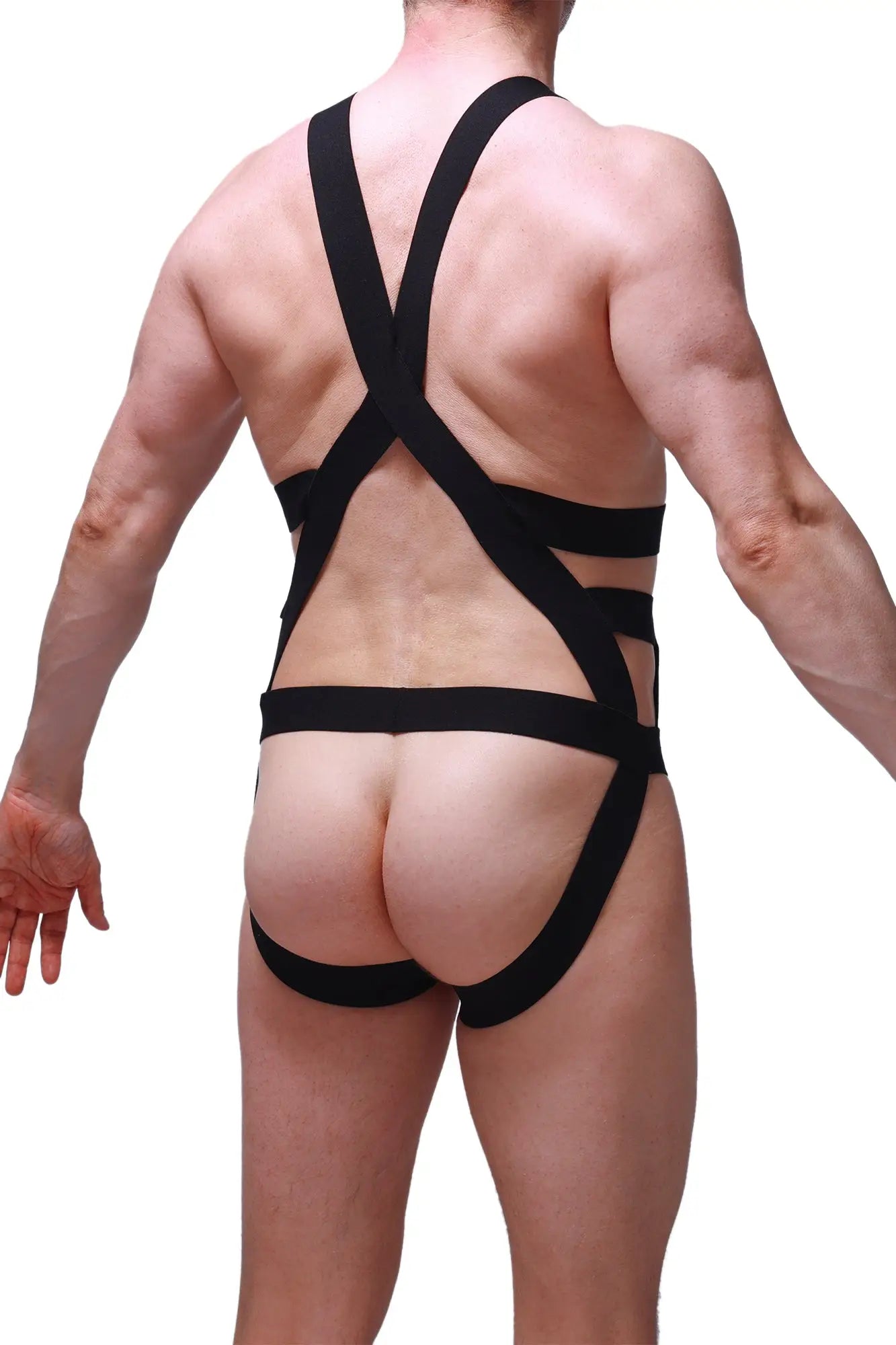 Back view of petitq jock harness champol black form-fitting harness-style bodysuit with crisscross straps and cutout design