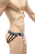 Pink lollipop-patterned petitq thong jockstrap with black elastic straps and branded waistband visible from back side