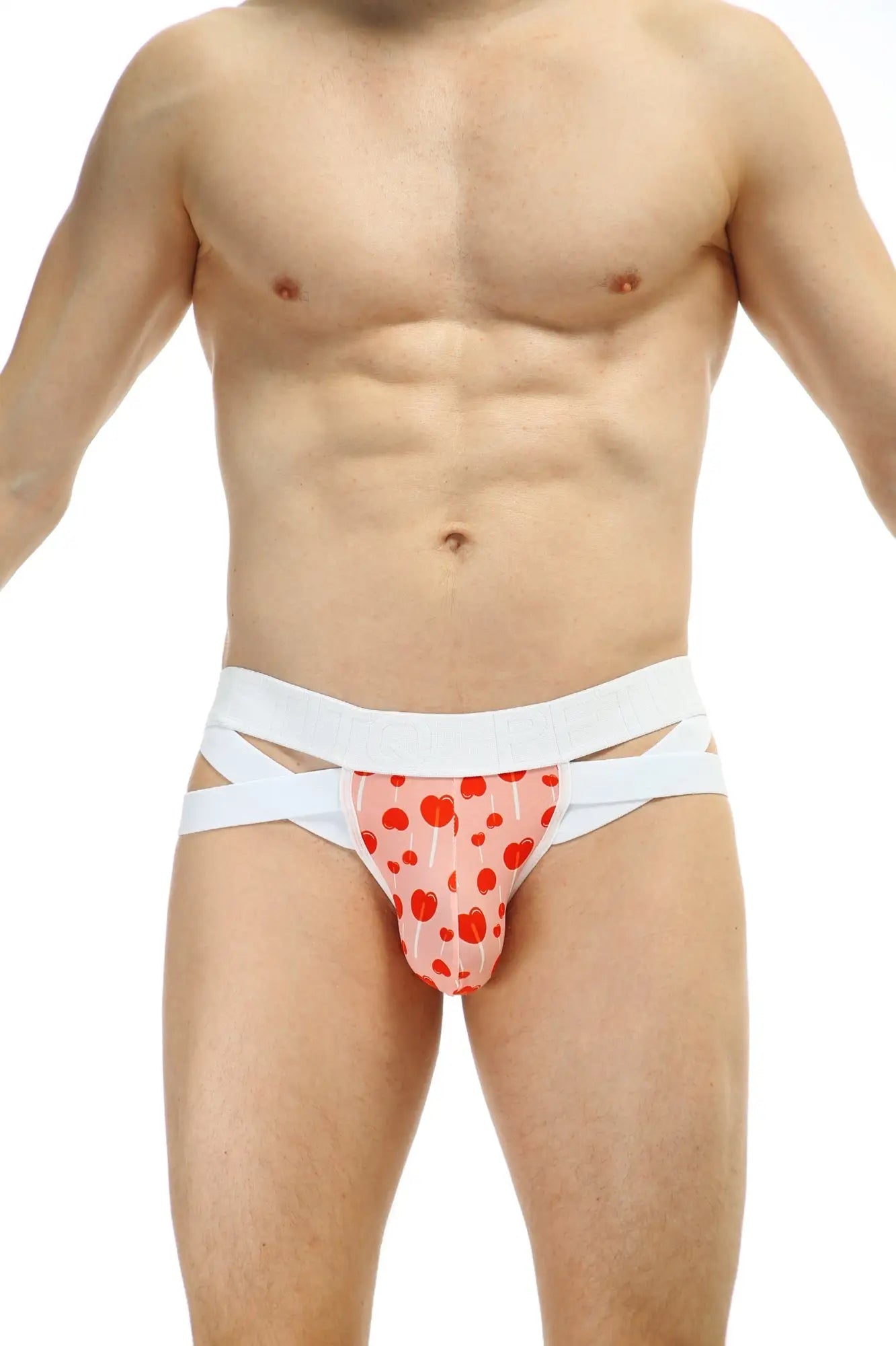 Petitq jockthong bost sucette pink heart-patterned briefs with white crisscross straps front view