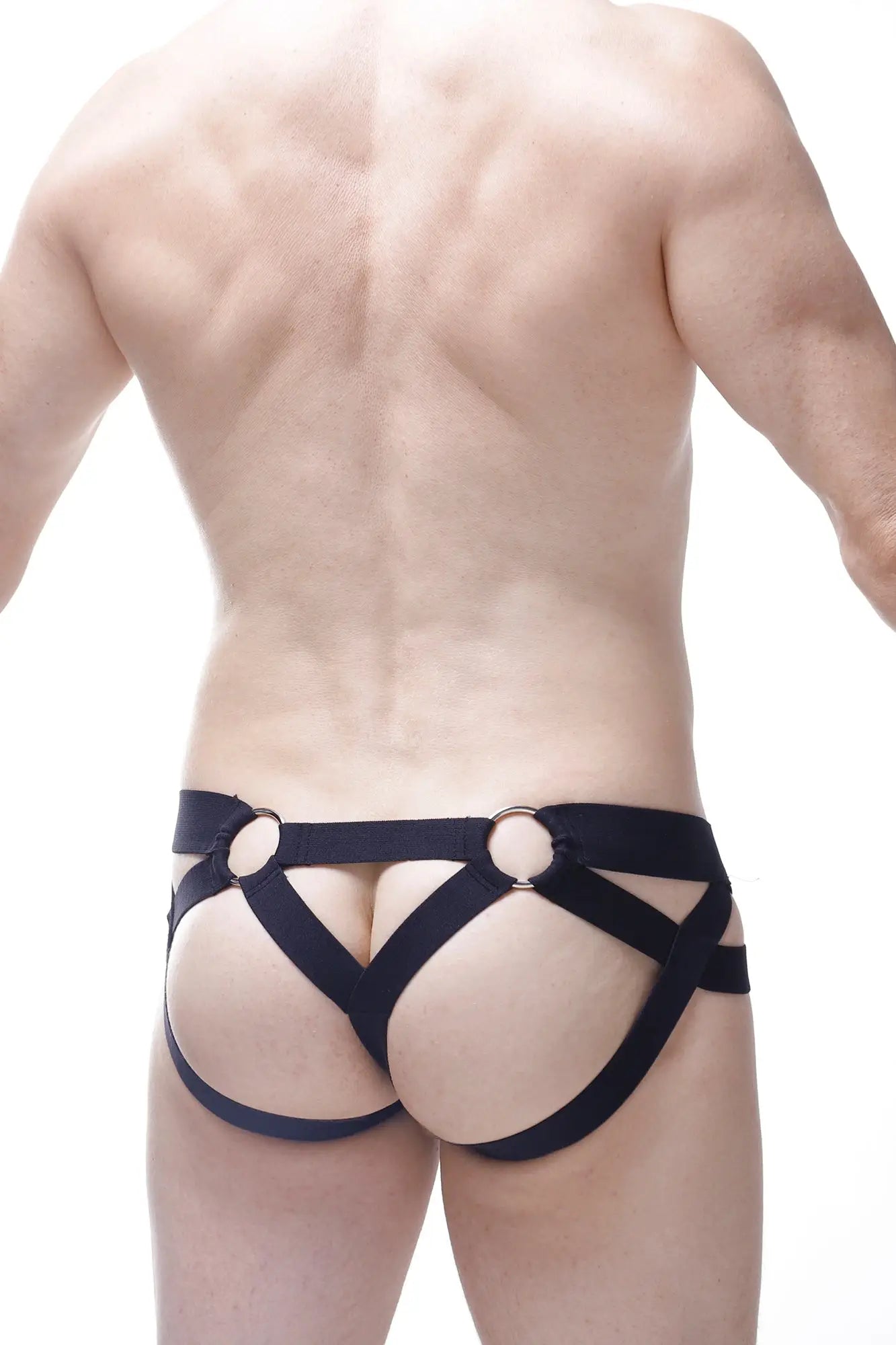 Black leather harness-style jock thong with metallic rings petitq jockthong post bee black shown from the back