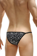 Black thong with white paisley and floral pattern from petitq kini bandana collection shown from the back side