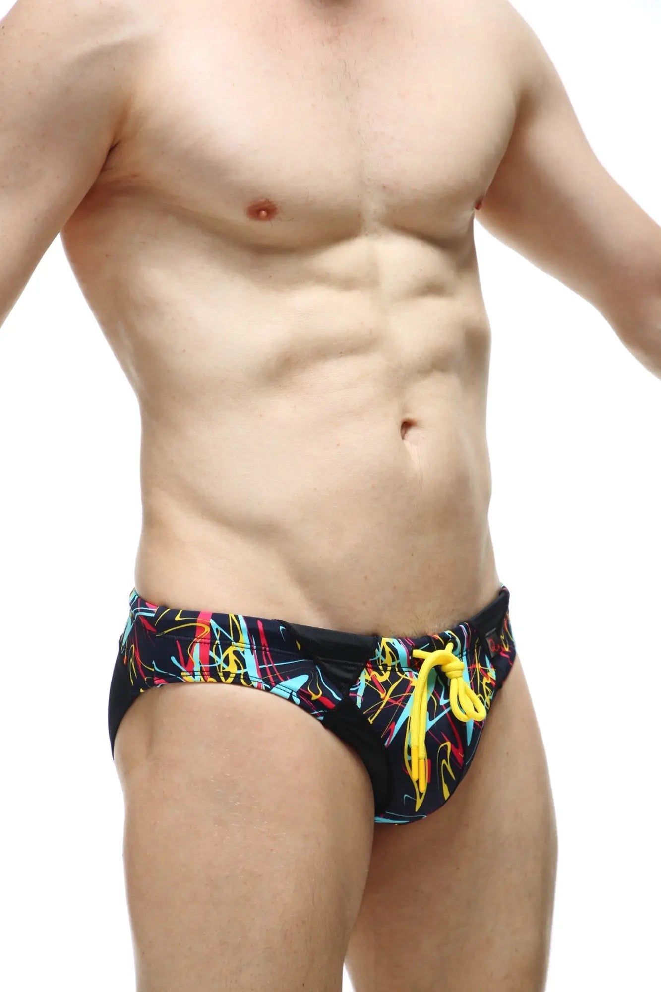 PetitQ swim bikini Lecci Conca black swim trunks with vibrant neon yellow cyan pink graffiti pattern and yellow drawstrings