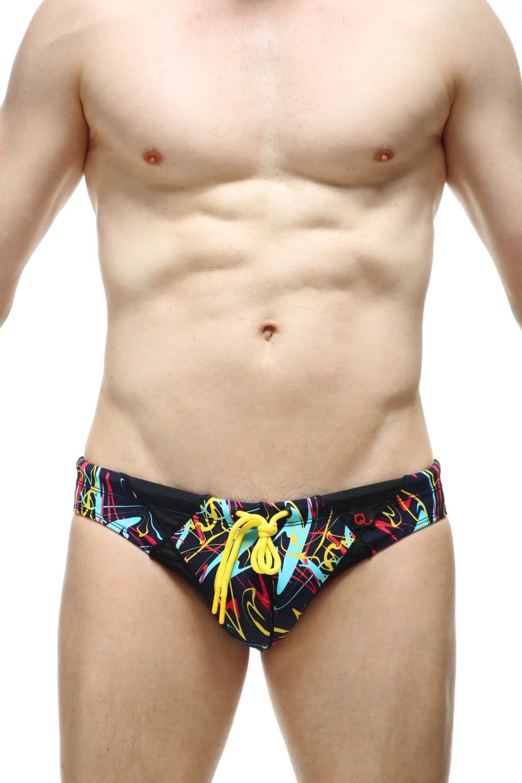 Black swim trunks petitq swim bikini lecci conca with vibrant neon graffiti pattern and bright yellow drawstrings