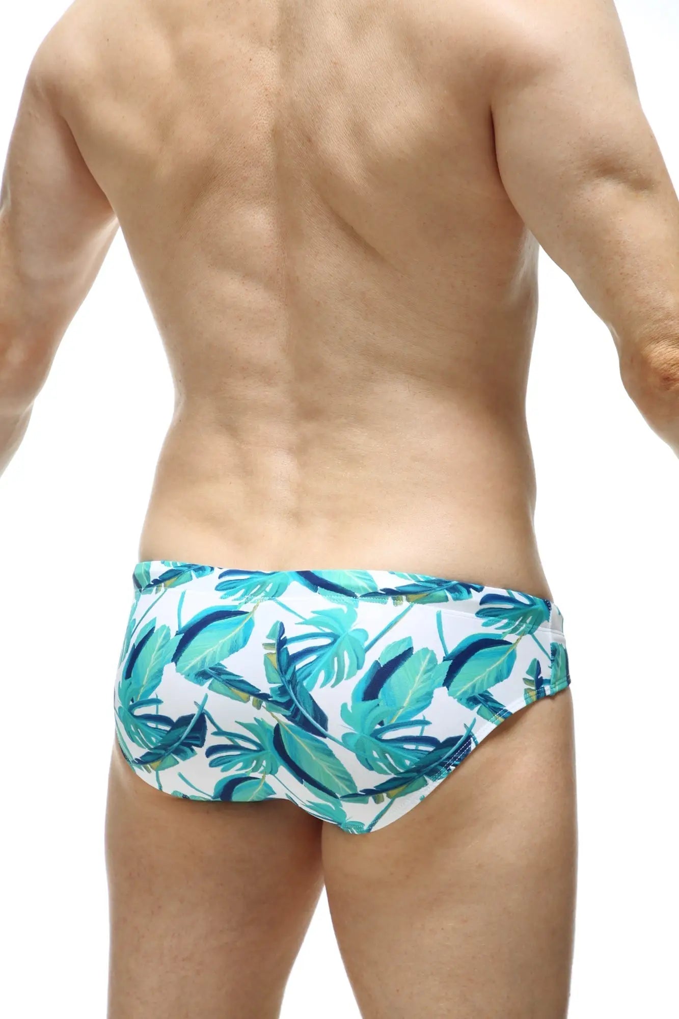White swim trunks petitq swim bikini macouba with vibrant teal and dark blue tropical leaf pattern for beachwear