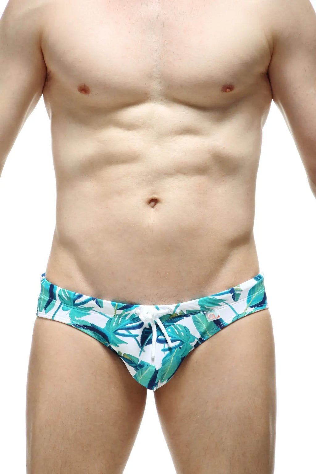 White swim trunks petitq swim bikini macouba with vibrant teal and green tropical leaf pattern and white drawstring waistband