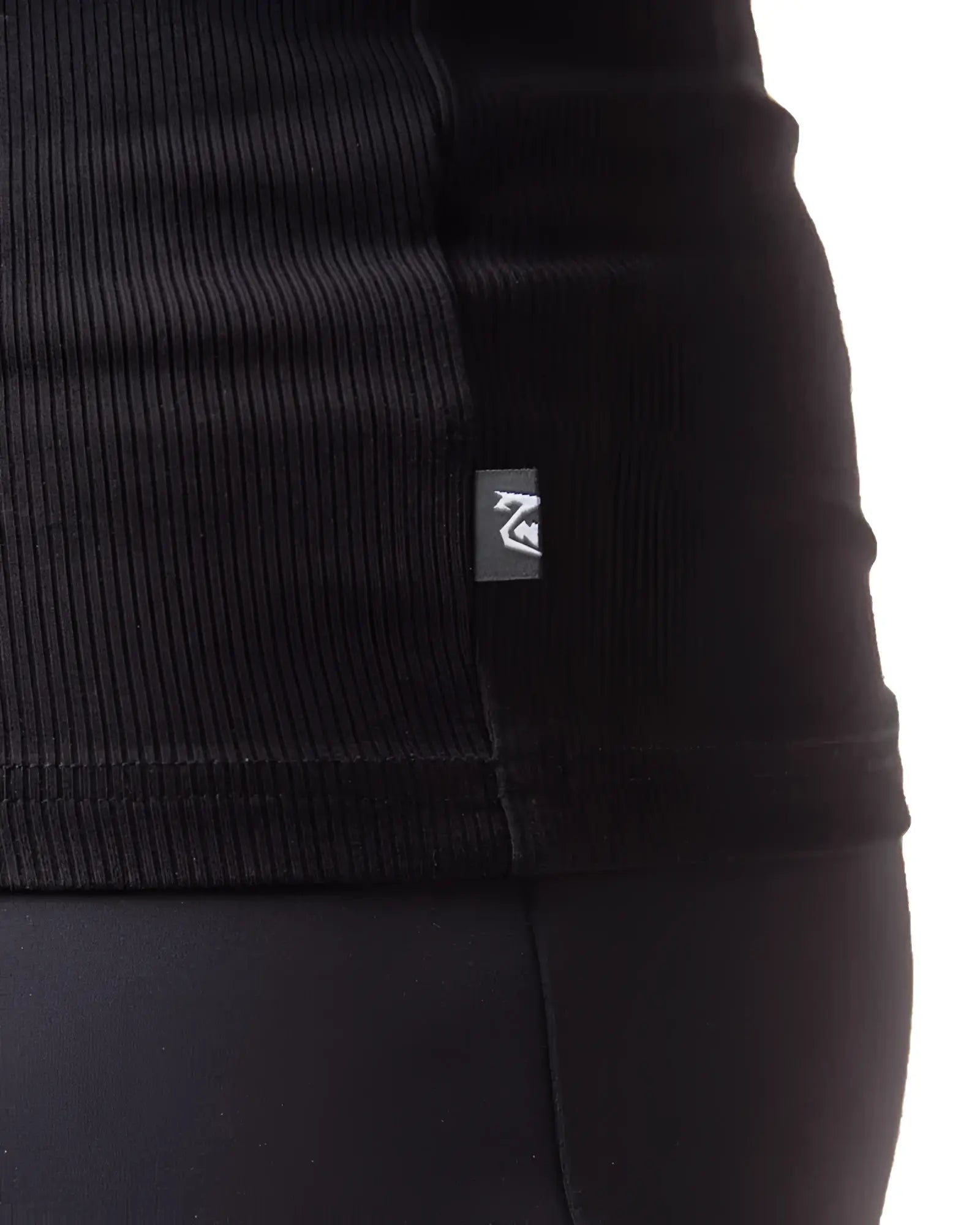 Black ribbed knit pig rib tank top with small rectangular brand tag on the seam