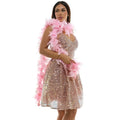 A shimmering rose gold sequined mini dress with v-neckline and flared skirt accessorized by a soft pink feather boa