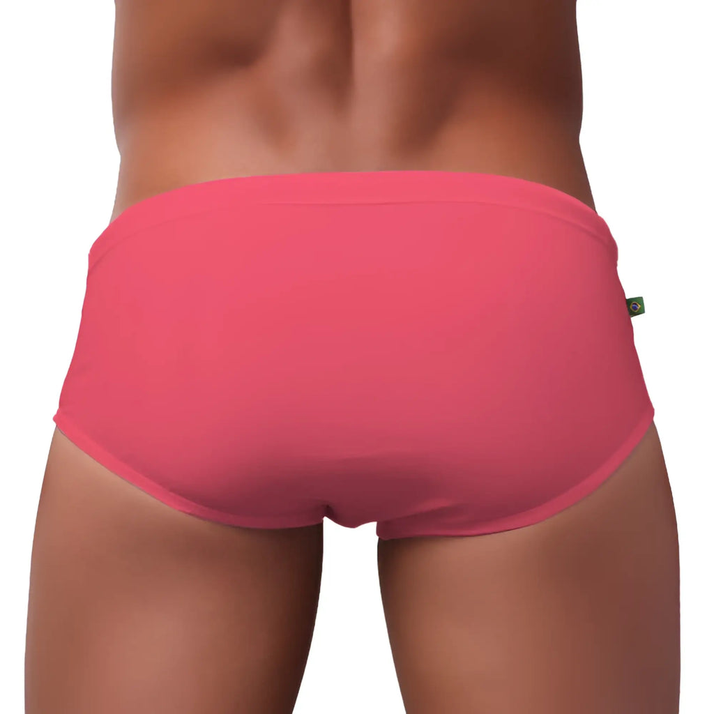 Bright pink men’s swimming sunga briefs made of smooth stretchy fabric with a simple elastic waistband for beachwear
