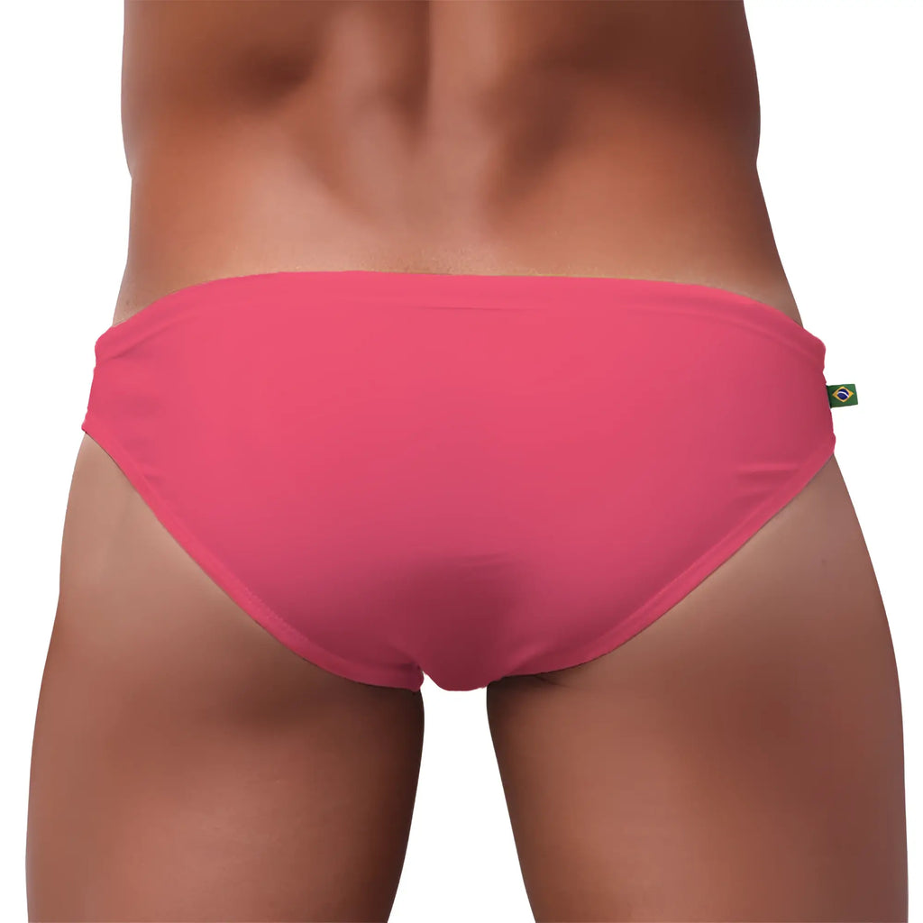 Bright pink form-fitting men’s swimming sunga with small brazilian flag tag perfect for beachwear
