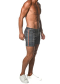 Dark gray plaid stretch knit shorts with subtle red and white striped side tape panel for casual wear