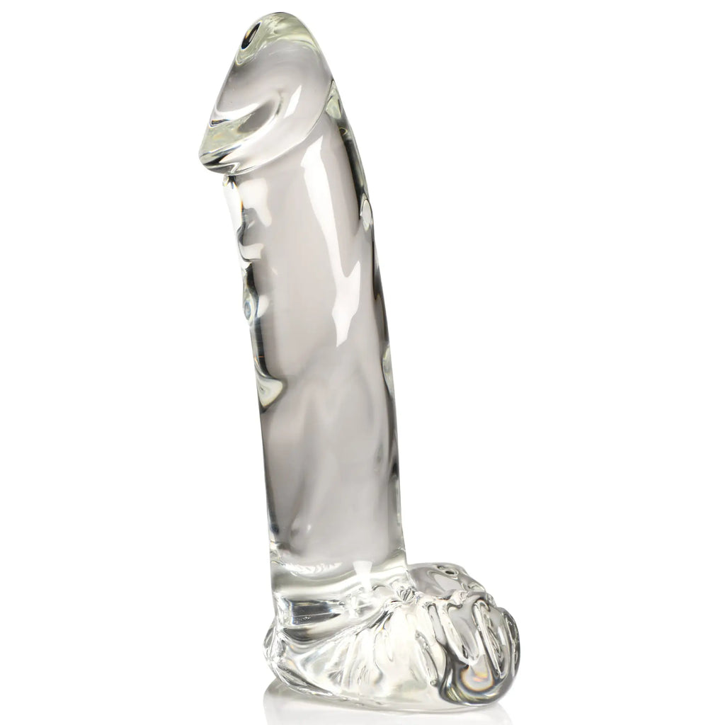 Pleasure Crystals clear glass dildo with realistic anatomical base and textured shaft, isolated on a white background.