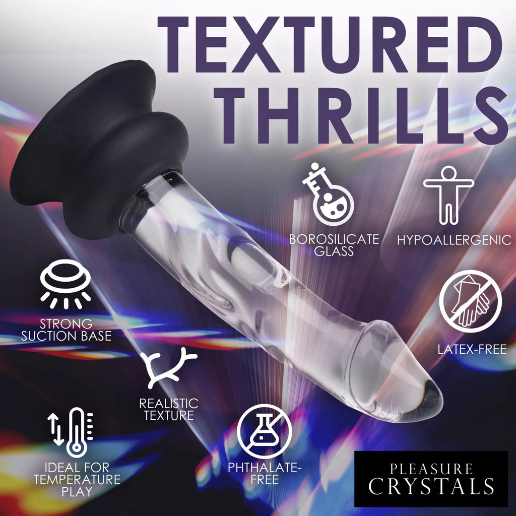 Pleasure Crystals glass dildo with a black silicone suction base, shown against a colorful, abstract light background.