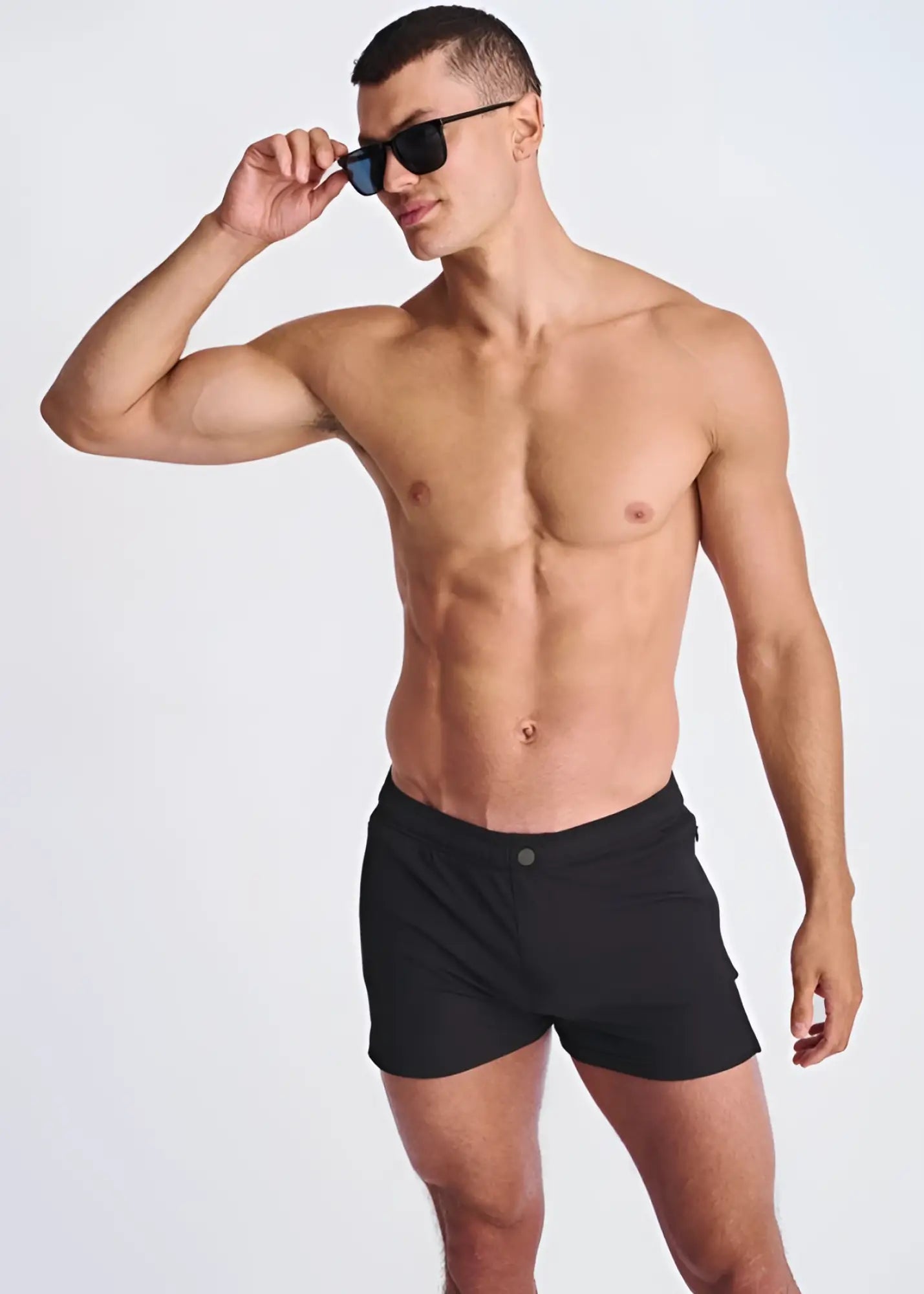 Black seersucker swim shorts with mesh lining and a single button closure at the waist for athletic use