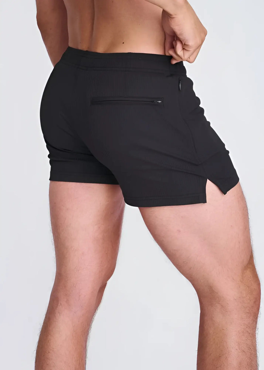 Black seersucker swim shorts with mesh lining showing back side with zippered pocket and side slit detailing