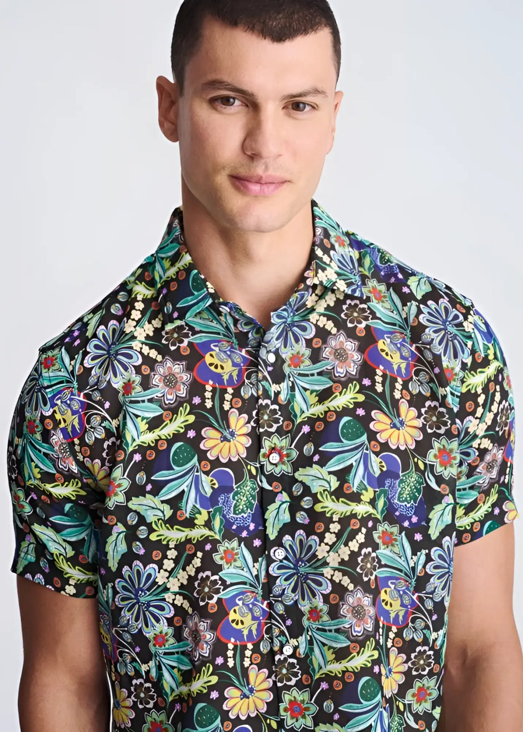 Floral lightweight linen tencel short sleeve shirt with vibrant green blue yellow and purple floral pattern on dark background