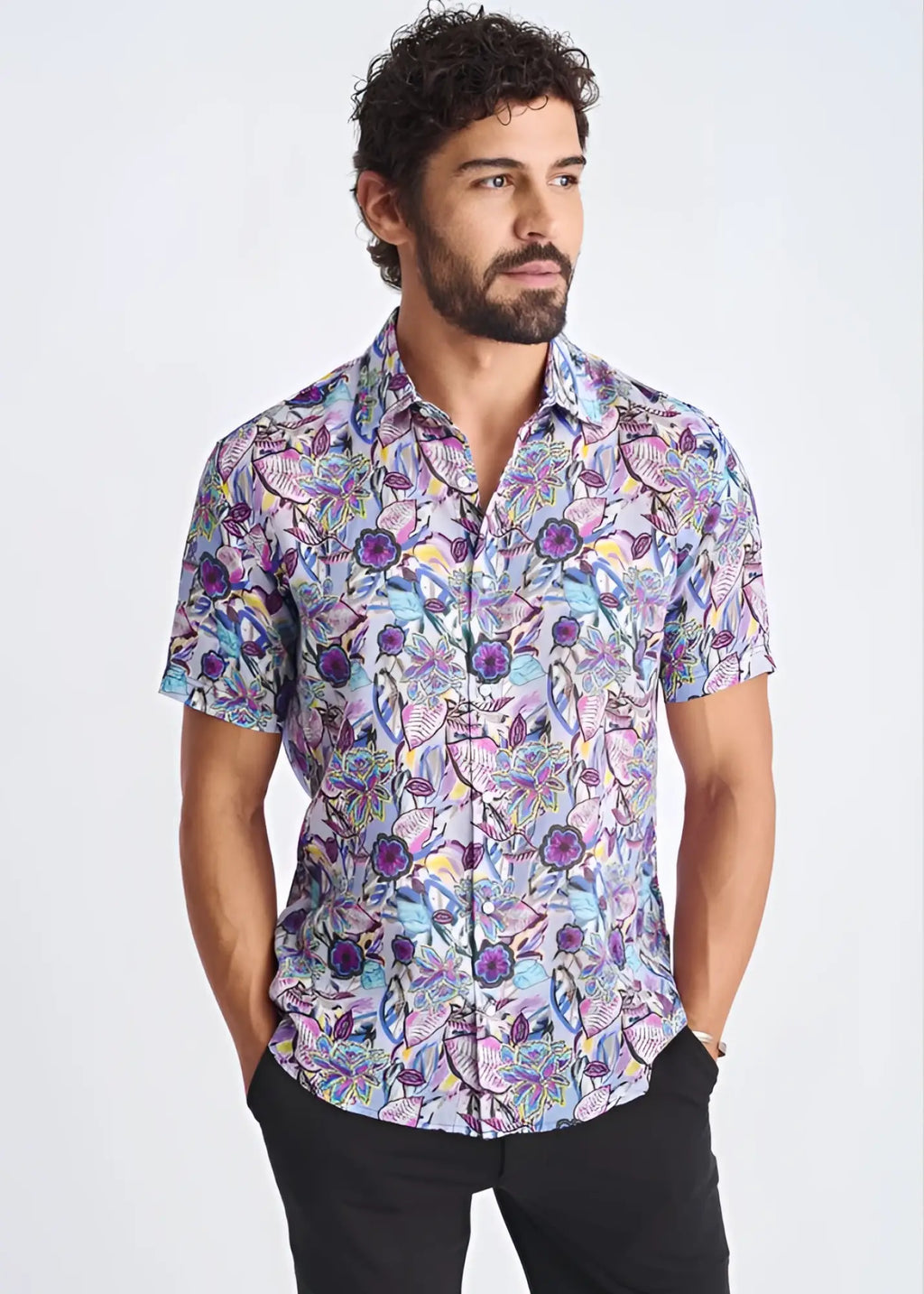 A vibrant floral lightweight linen tencel short-sleeved shirt in purple blue and pink on a light lavender background