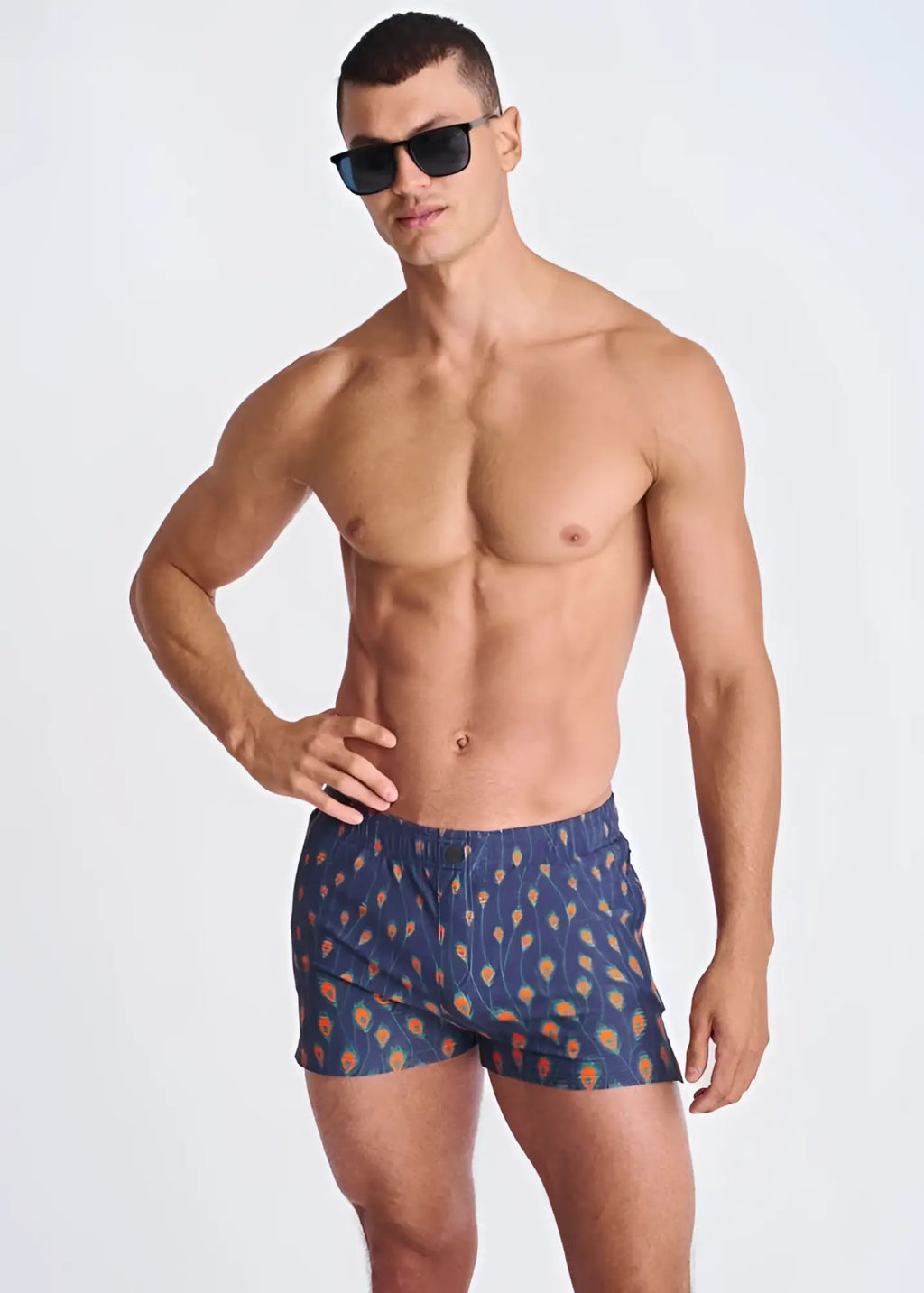 Blue swim trunks with orange and yellow feather pattern made of seersucker with mesh lining for swimming