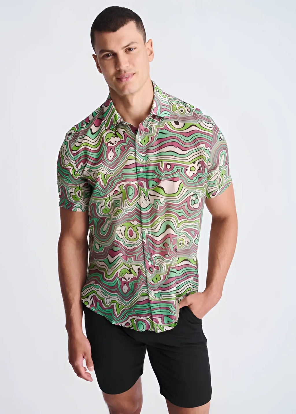 A vibrant short-sleeved button-up shirt in green pink and white psychedelic swirls made from lightweight cotton silk