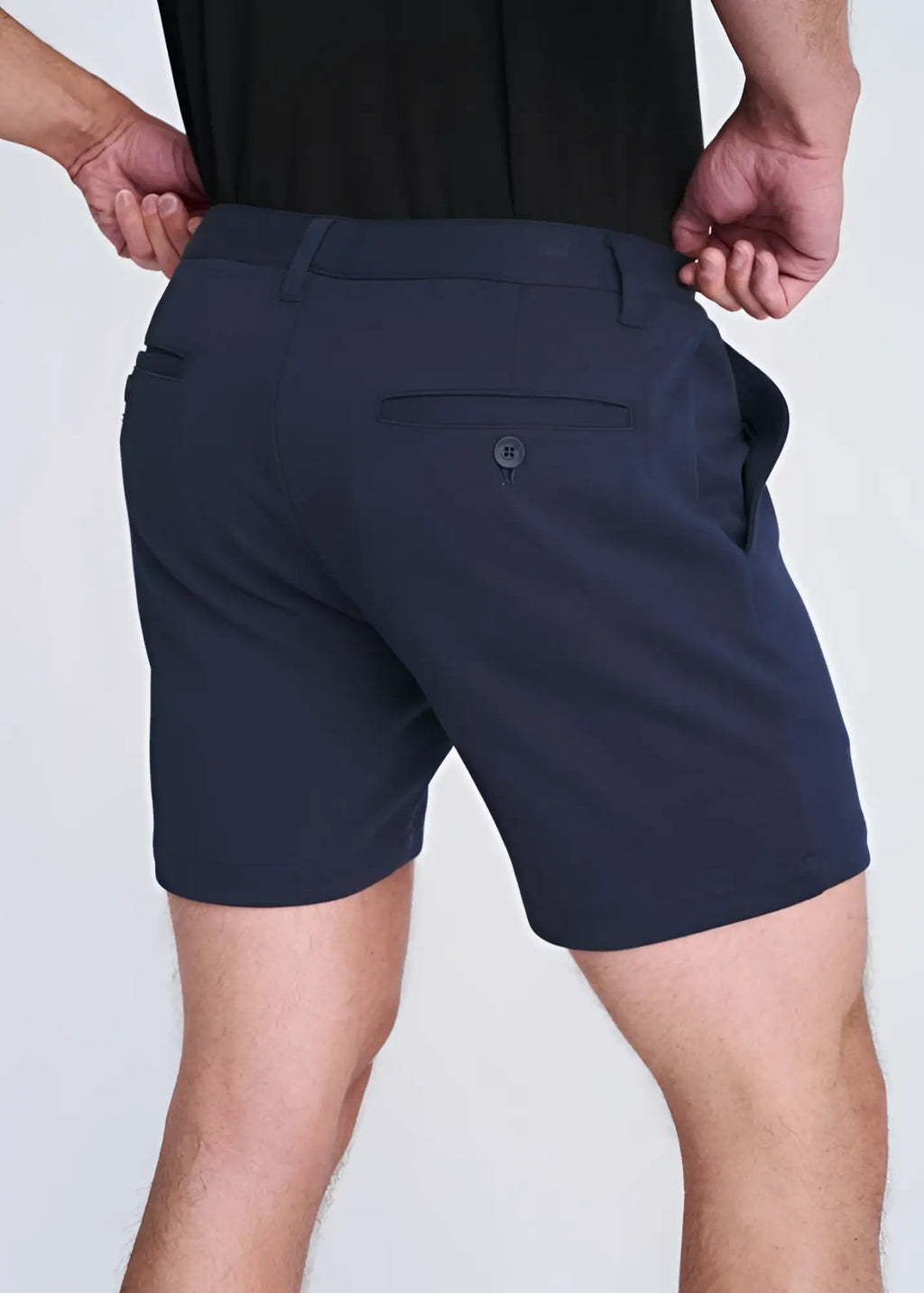 Dark navy blue textured stretch knit chino shorts with tailored fit and subtle button detail on the back pocket view