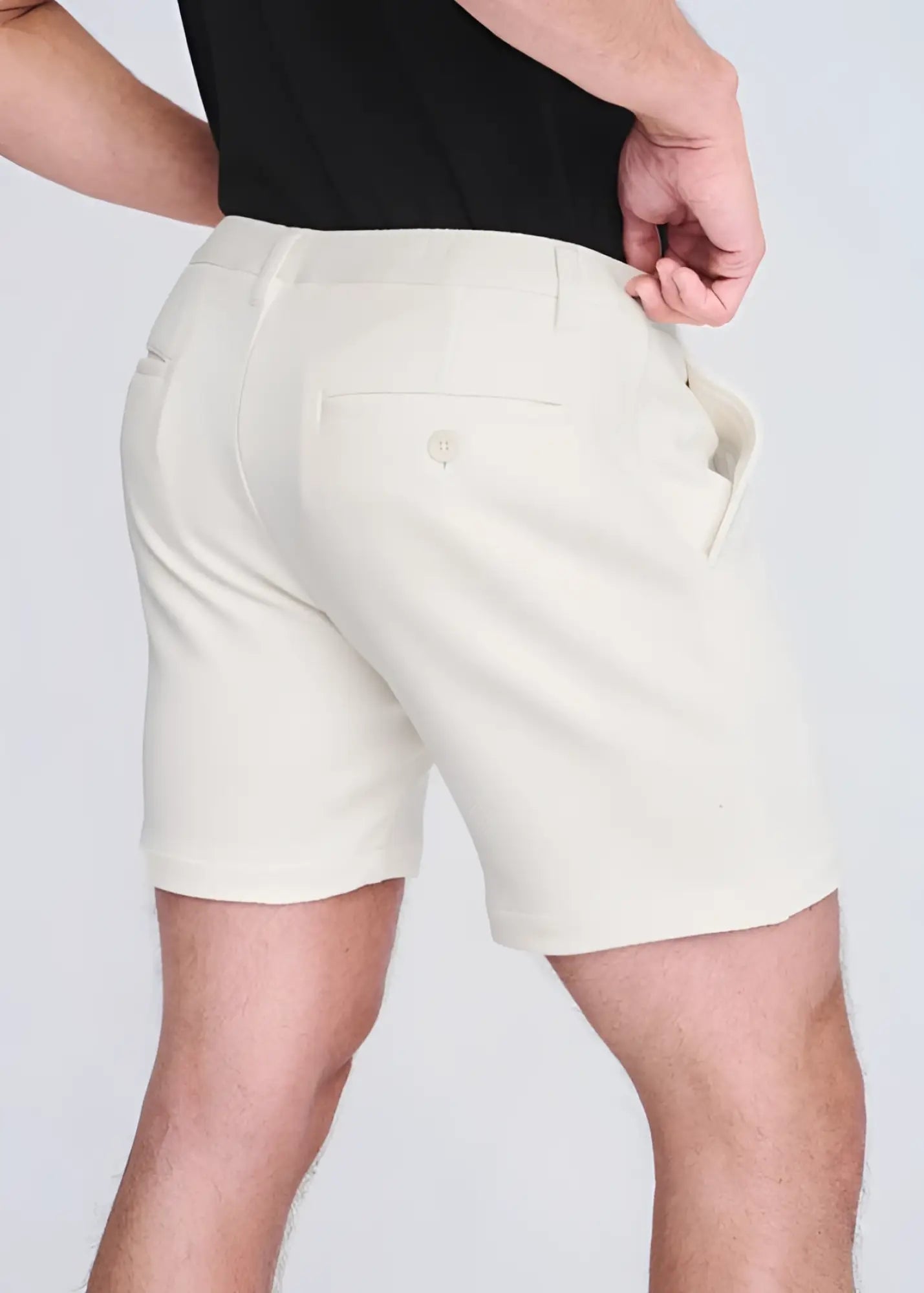 Cream-colored textured stretch knit chino shorts shown from the back with tailored fit and buttoned pocket detail