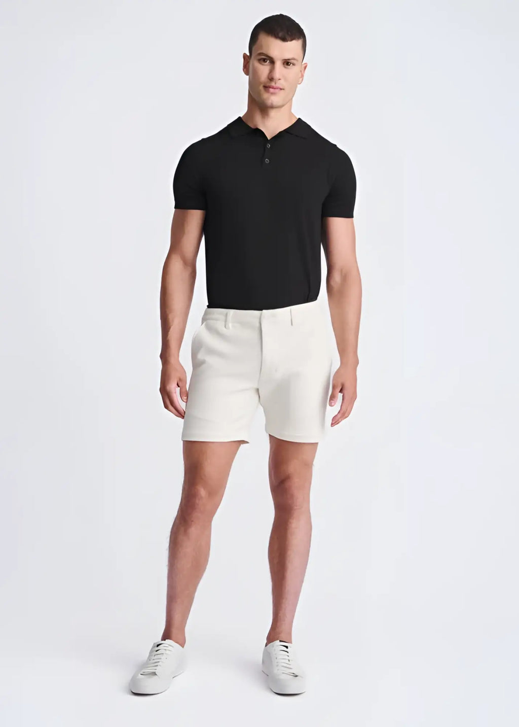 A pair of white textured stretch knit chino shorts with a tailored fit and belt loops