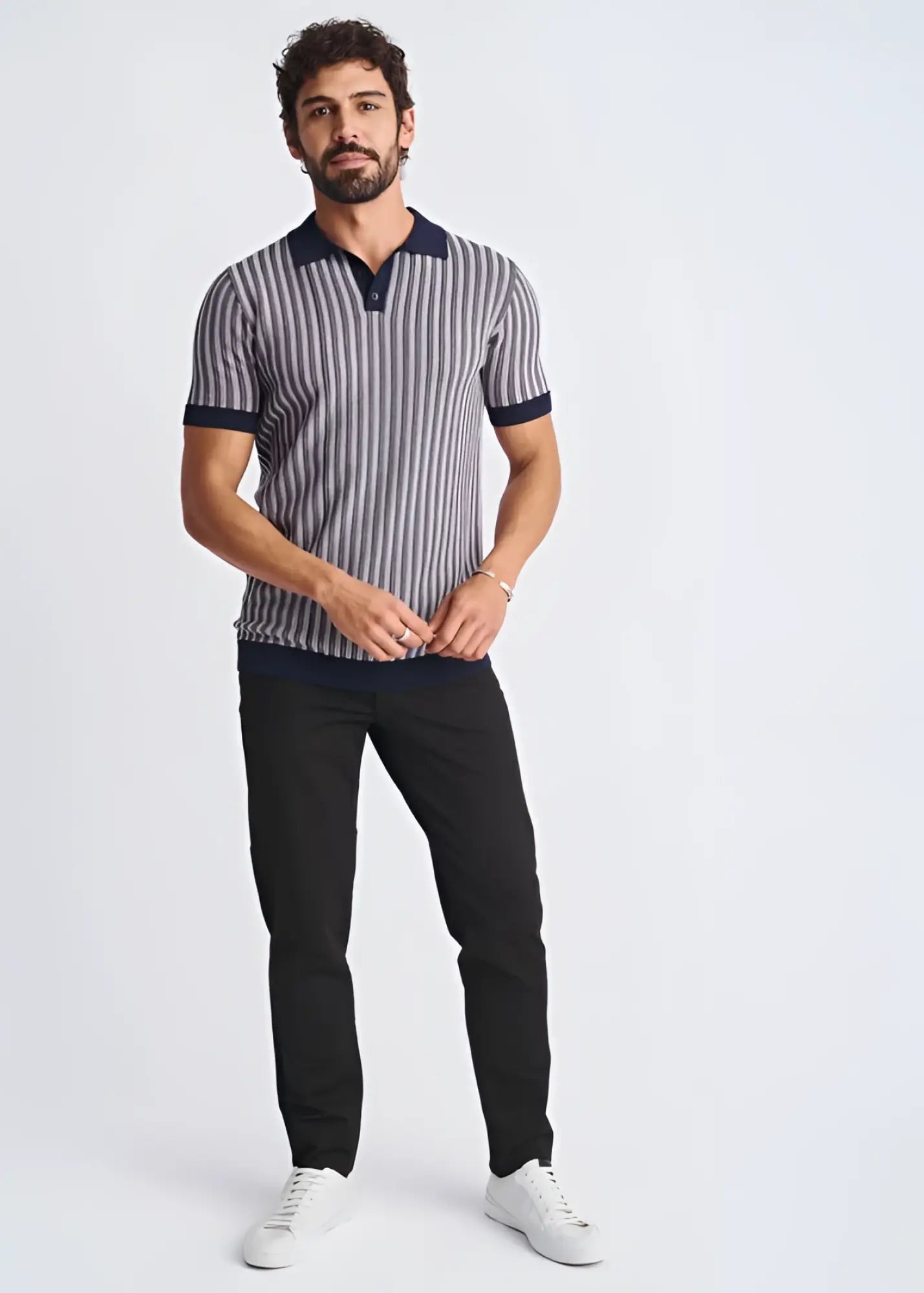 A man wearing a textured stripes silk tencel polo shirt in navy and gray with dark blue collar and sleeve cuffs