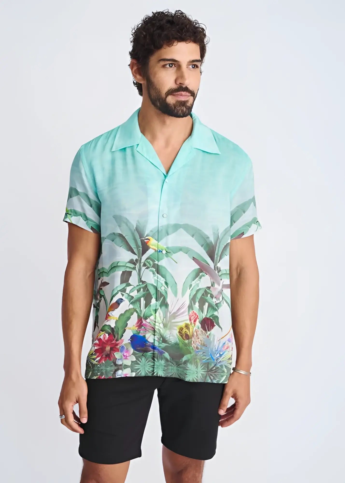 A vibrant turquoise tropical print short-sleeved modal shirt with birds and foliage named tropics border print s s modal shirt
