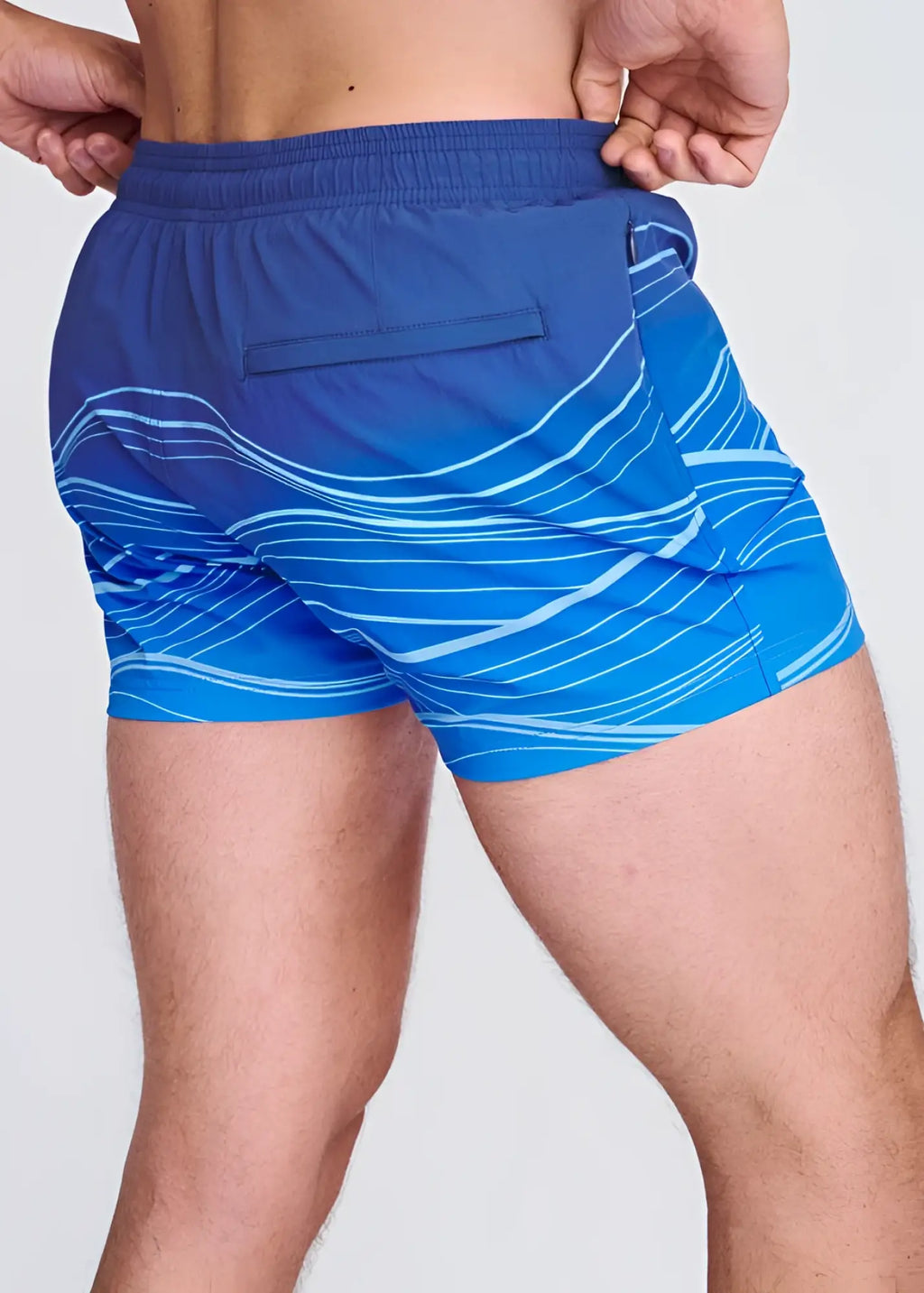 Blue swim shorts with white wavy line print and mesh lining designed for comfortable beach and pool use