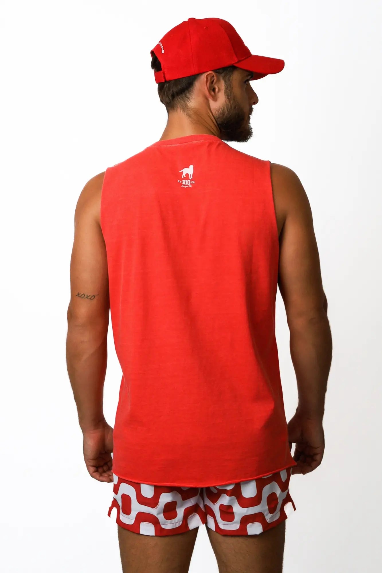 Back view of a red sleeveless athletic tank top with a small white logo on the back men’s posto 9 ipanema tee