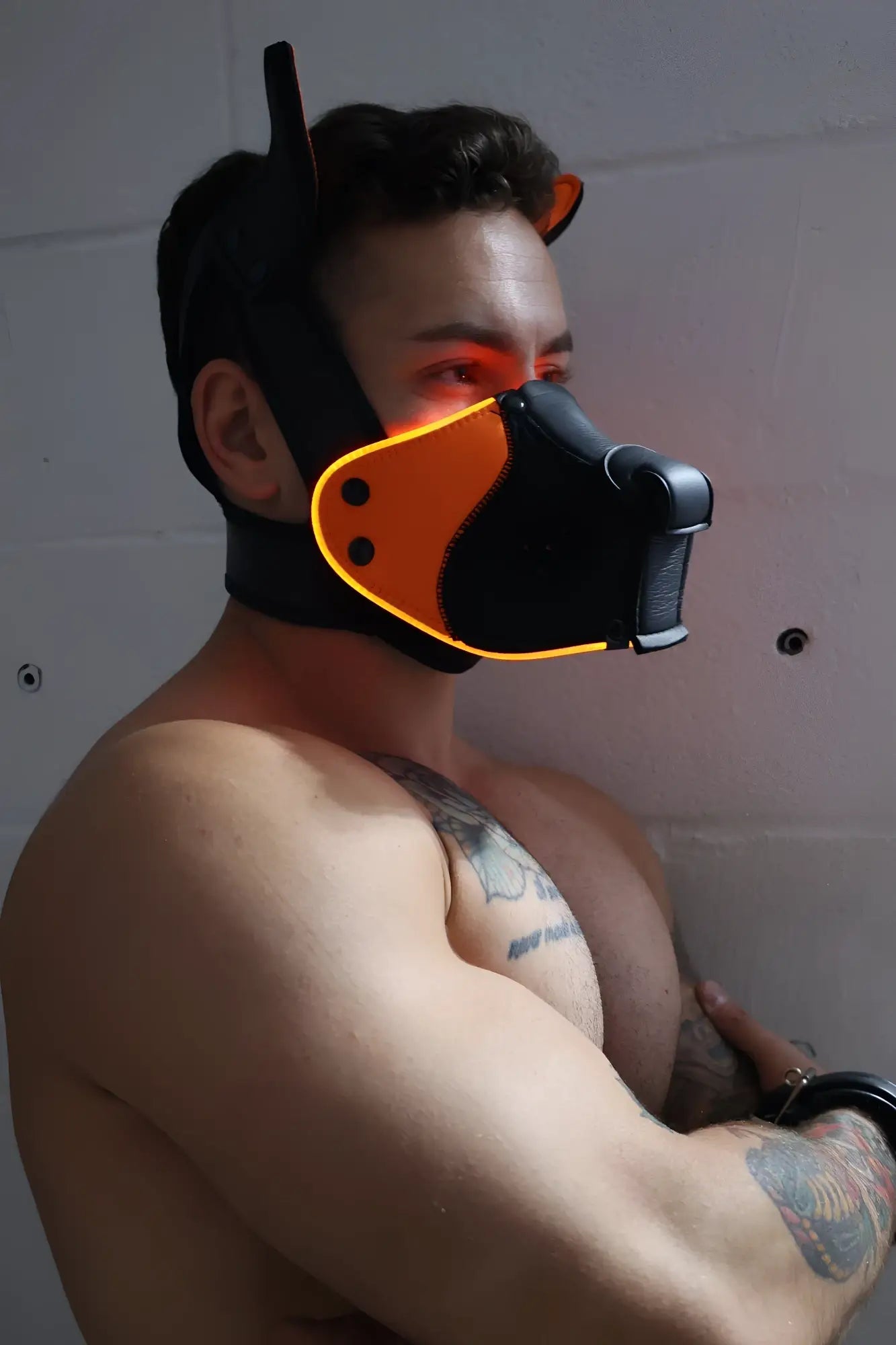 Poundtown Pup Mask 2.0 neon orange is a black and orange dog mask with glowing yellow trim for costume use