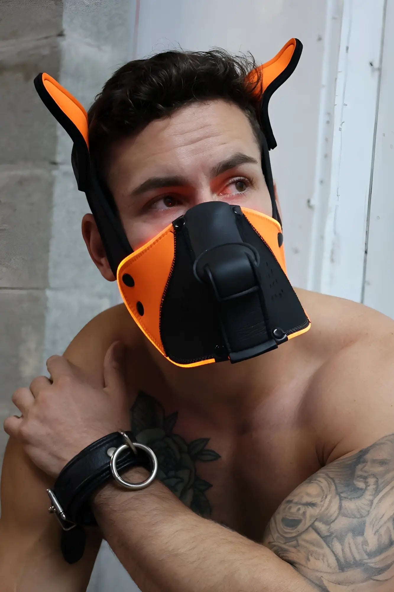Orange and black leather dog muzzle with ear-like protrusions poundtown pup mask 2.0 neon orange