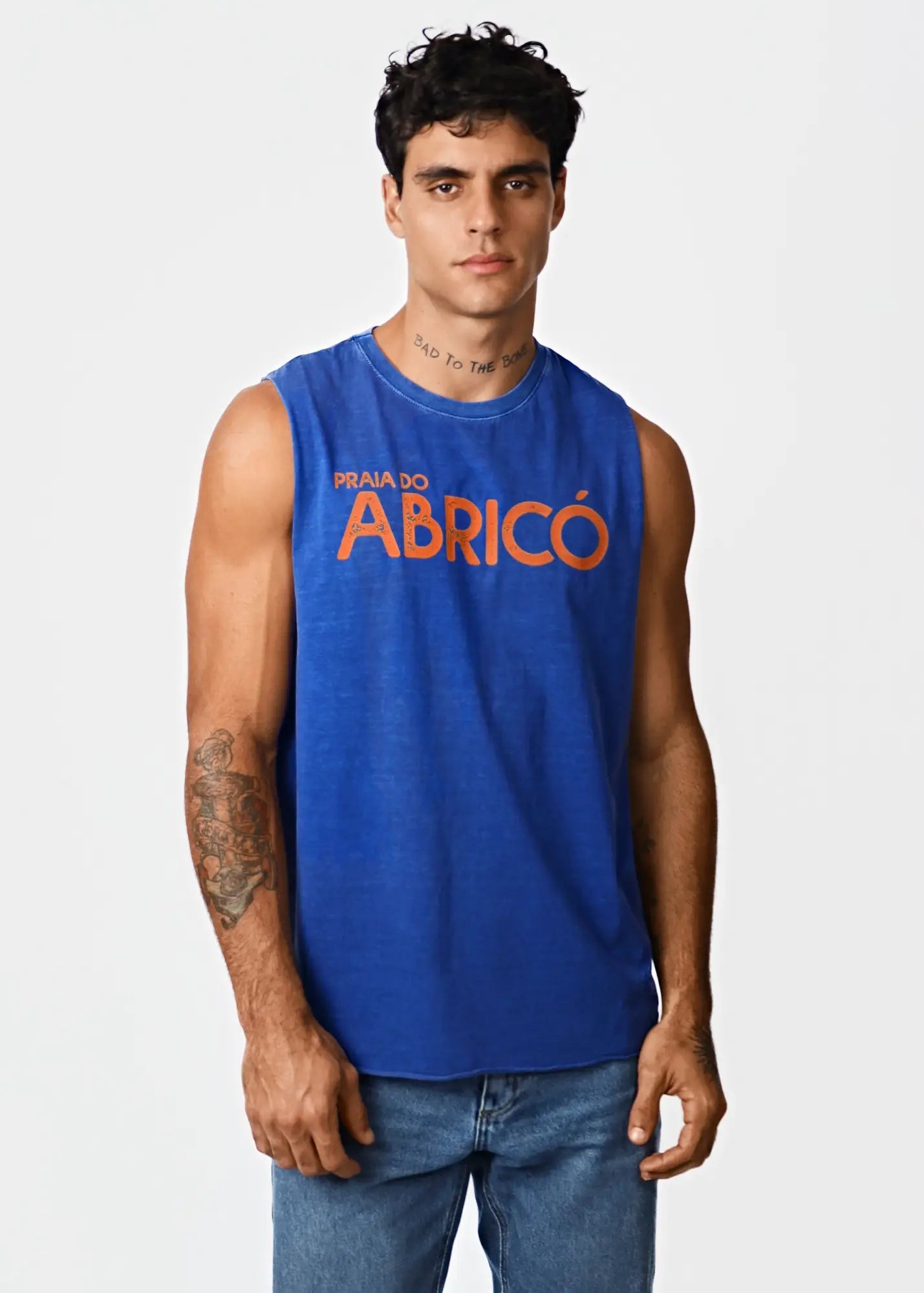 Blue sleeveless tank top with orange praia do abricó text for men inspired by Rio famous nude beach style
