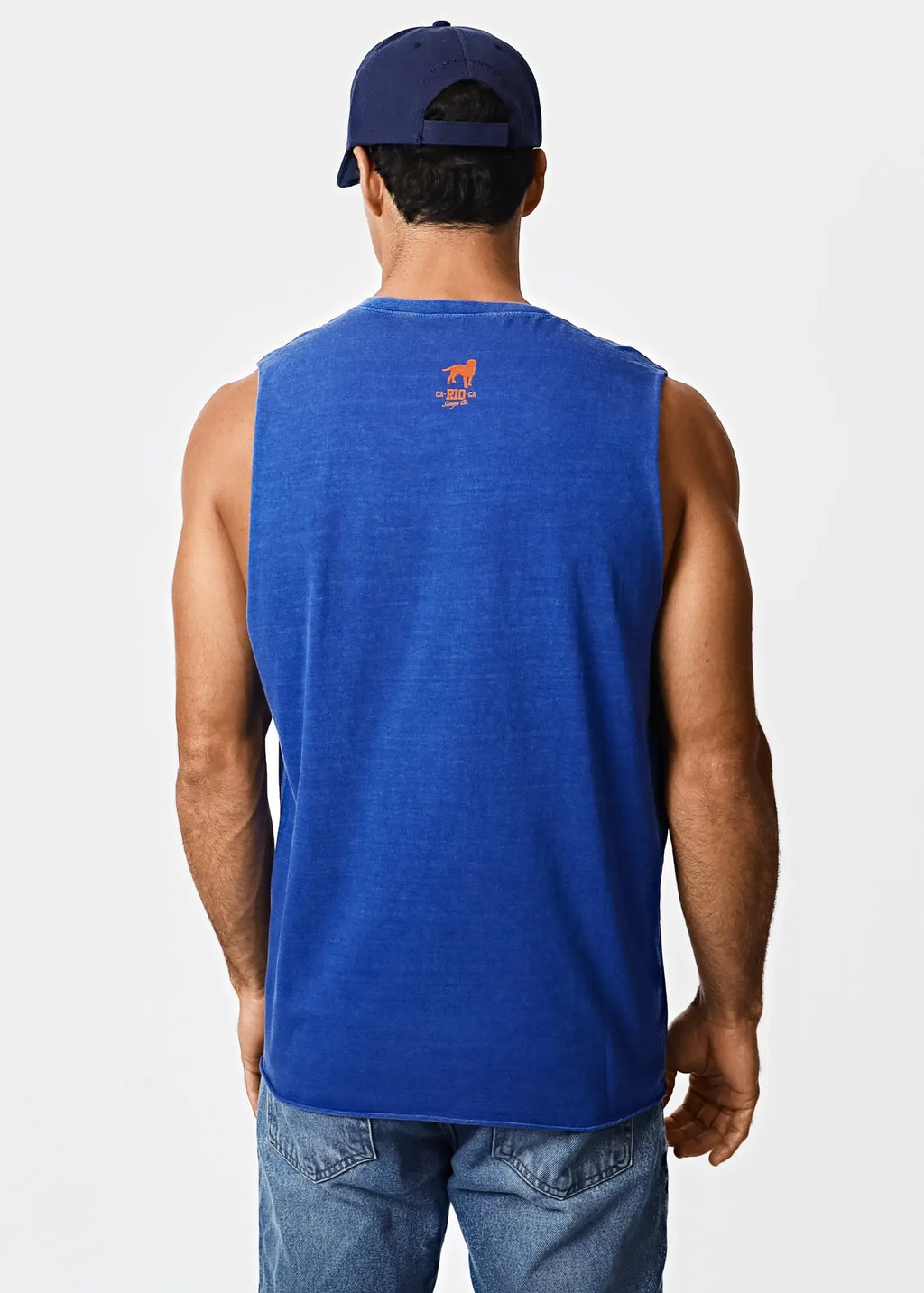 A man wears a royal blue sleeveless t-shirt with a small orange dog logo on the back.