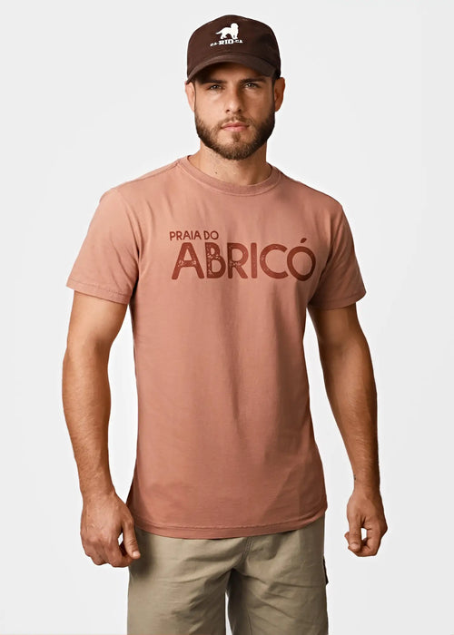 Men’s dusty rose cotton t-shirt with bold dark brown praia do abricó graphic for rio famous nude beach