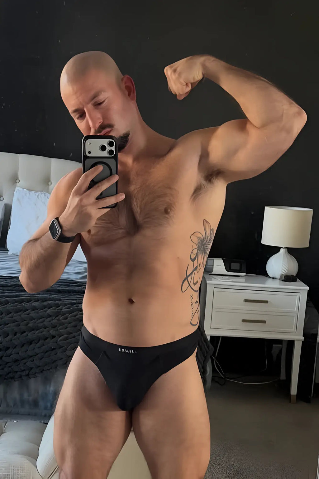 Black premium modal athletic thong with subtle white logo on waistband designed for comfort and performance