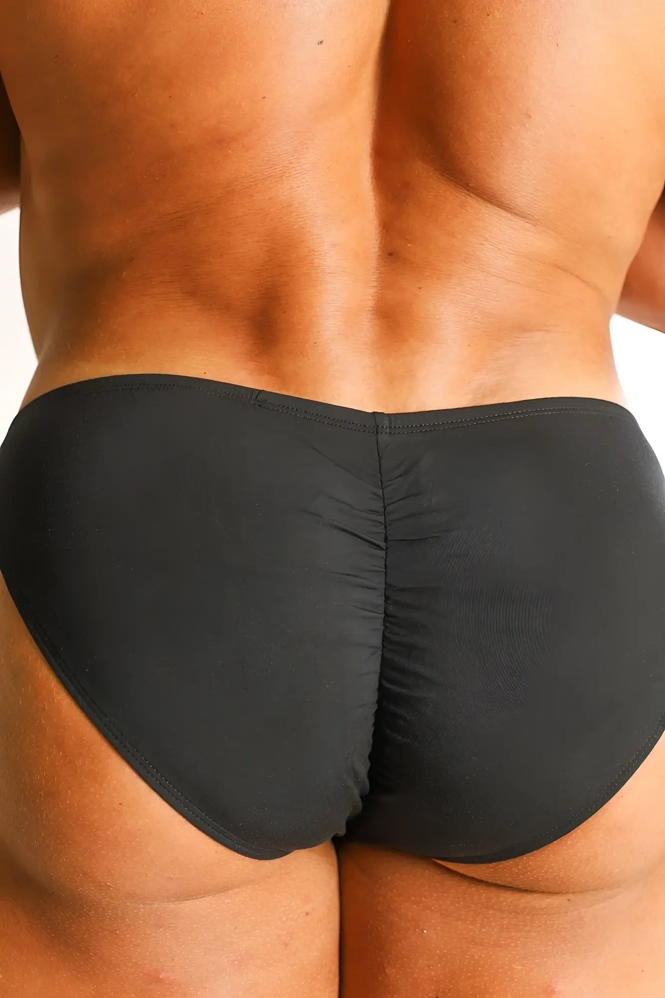 Back view of premium modal scrunch back briefs in noir black with a ruched design for a flattering fit