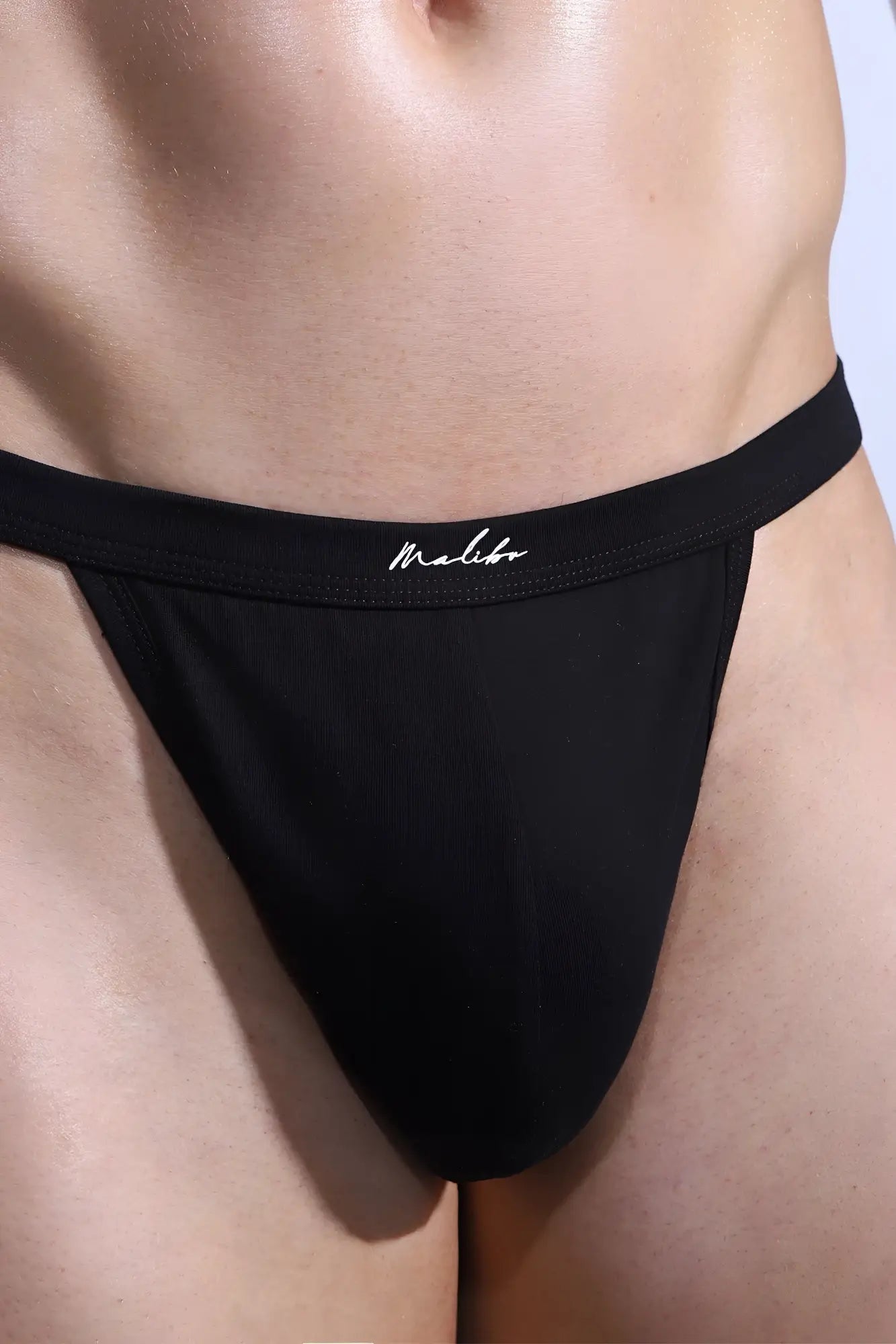 Black Malibu premium versatile thong for men in obsidian black made of smooth stretchy fabric with white script logo on waistband