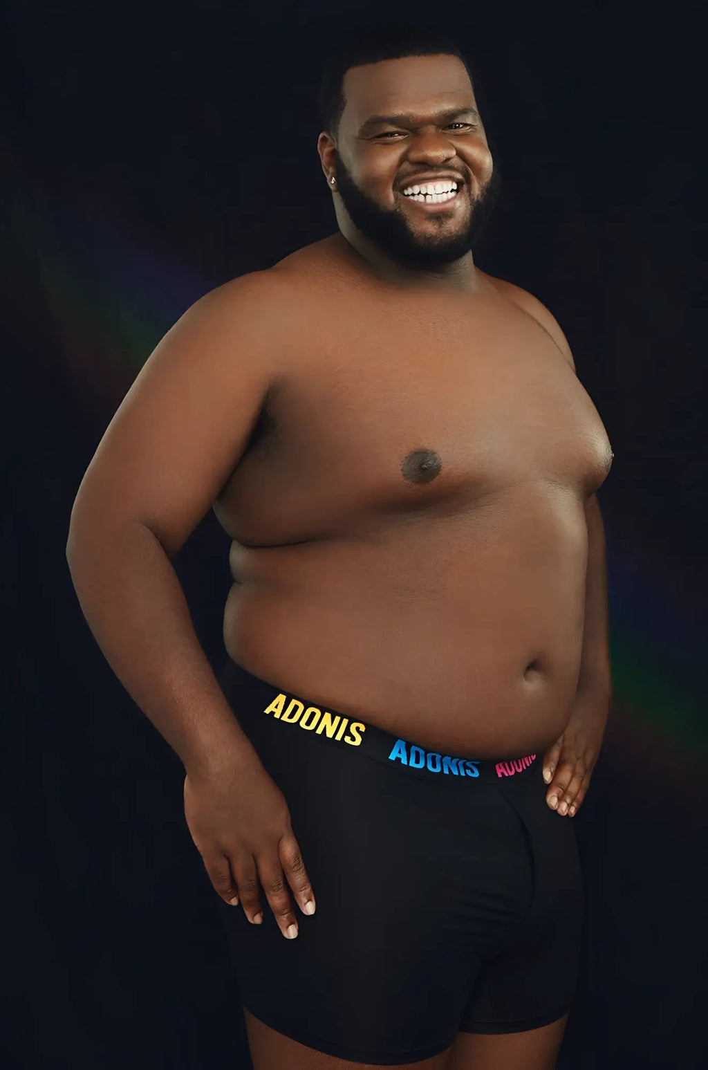 Black pride boxer shorts featuring adonis in yellow blue and pink lettering on the waistband