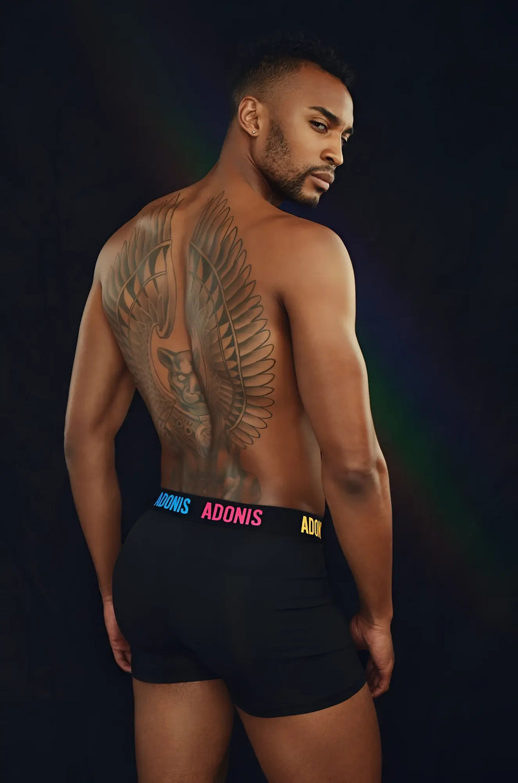 Black briefs with a colorful adonis waistband featuring pink and yellow lettering from pride boxer shorts collection