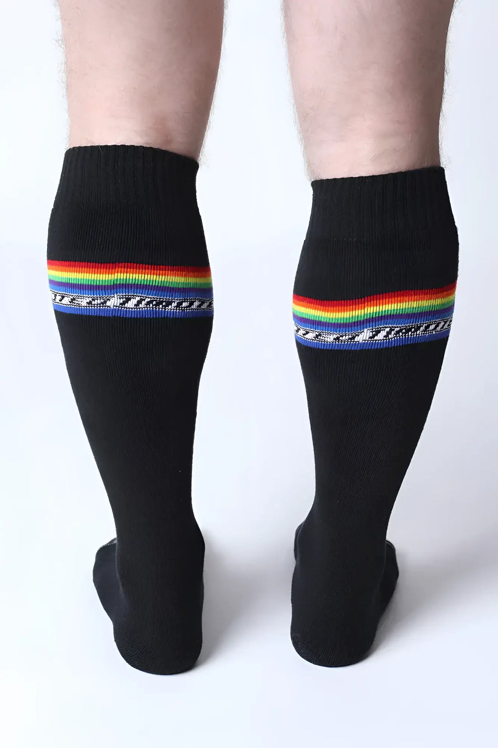 Black pride knee high socks with vibrant rainbow stripes and white military text below the stripe